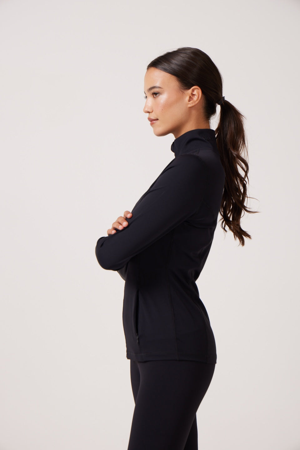 Black Lightweight performance jacket with a smooth, sculpting fit, full zip front, high collar, and stretch fabric designed for everyday movement and layering.