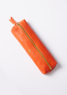 Leather Vanity Bags — assorted colors including orange, pink, red, tan, and black, each with gold zipper detail