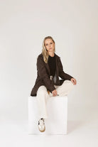 Truffle Haze raincoat in dark brown, lightweight hooded waterproof raincoat ideal for South Africa’s rainy season and wet climate