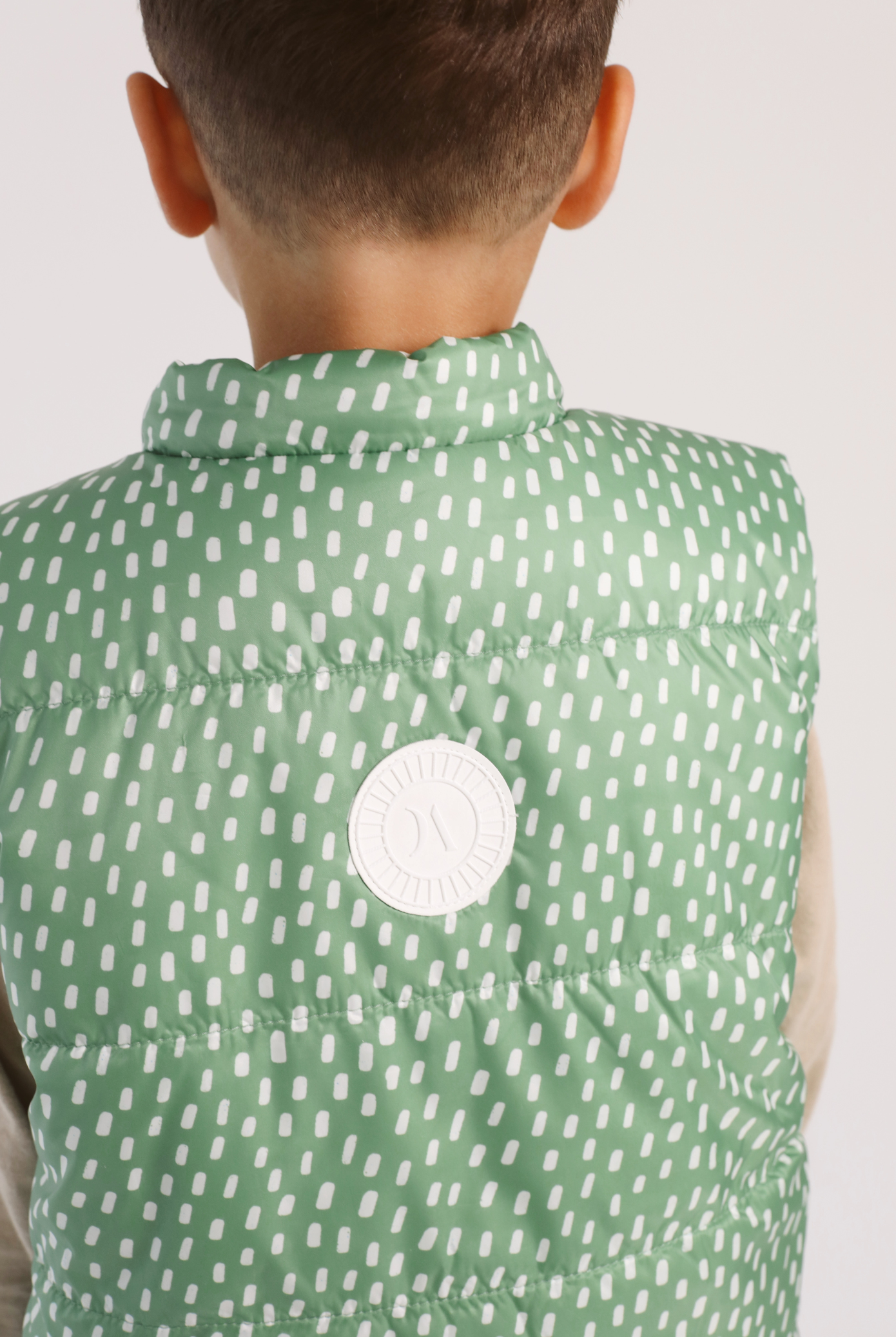 Kids Dots x Green Gilet™ — lightweight sleeveless puffer vest with playful white dot print on green, perfect for layering in South Africa