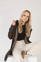 Truffle Haze raincoat in dark brown, lightweight hooded waterproof raincoat ideal for South Africa’s rainy season and wet climate