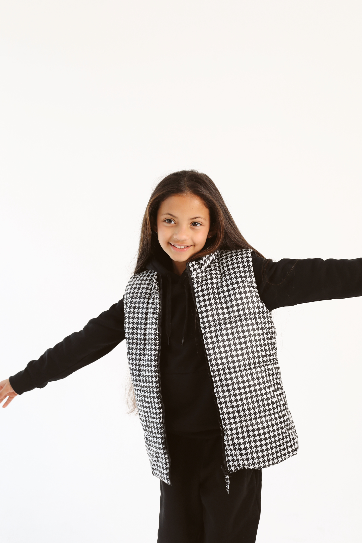 Kids Houndstooth x Black Gilet™ — sleeveless black puffer vest with bold houndstooth print, a versatile winter layer for kids in South Africa