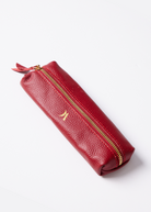 Leather Vanity Bags — assorted colors including orange, pink, red, tan, and black, each with gold zipper detail