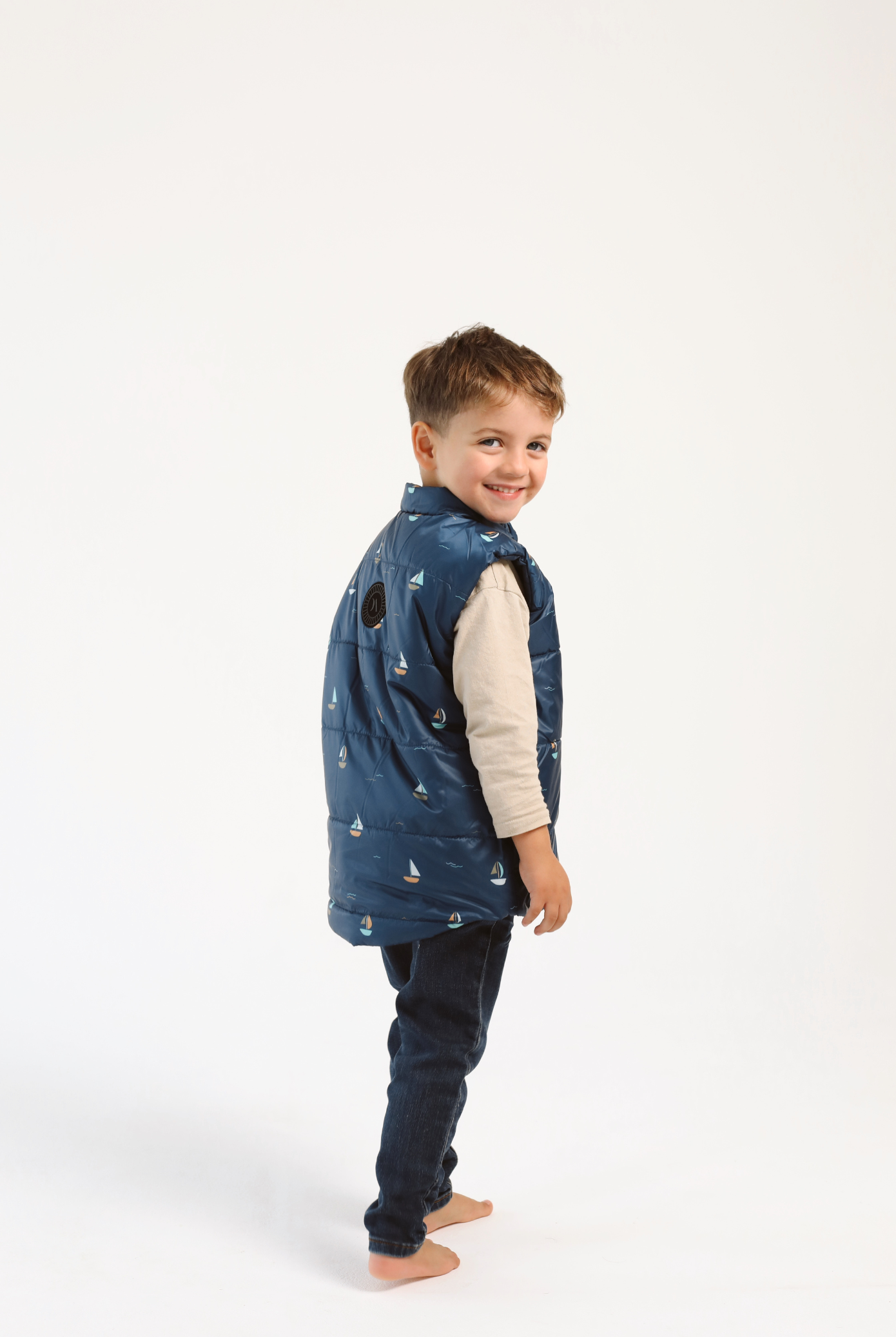 Kids Boats x Navy Gilet™ — sleeveless navy puffer vest with playful boat print, a versatile layer for kids in South Africa