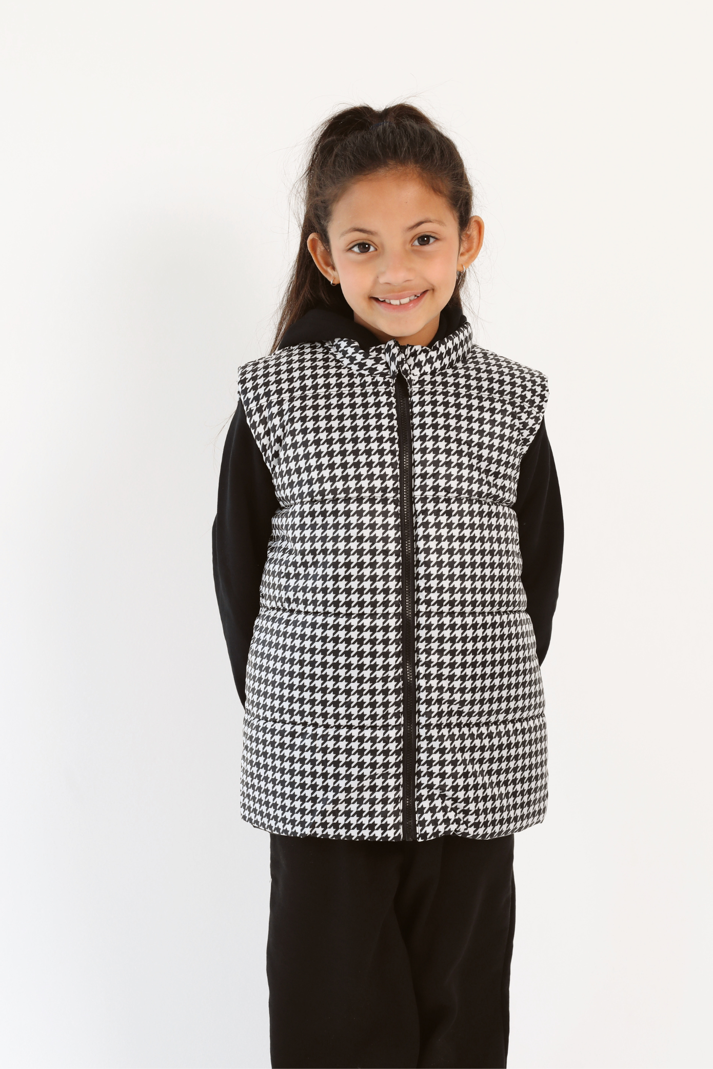 Kids Houndstooth x Black Gilet™ — sleeveless black puffer vest with bold houndstooth print, a versatile winter layer for kids in South Africa