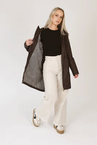 Truffle Haze raincoat in dark brown, lightweight hooded waterproof raincoat ideal for South Africa’s rainy season and wet climate