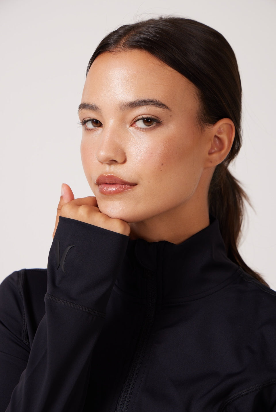 Black Lightweight performance jacket with a smooth, sculpting fit, full zip front, high collar, and stretch fabric designed for everyday movement and layering.