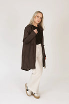 Truffle Haze raincoat in dark brown, lightweight hooded waterproof raincoat ideal for South Africa’s rainy season and wet climate