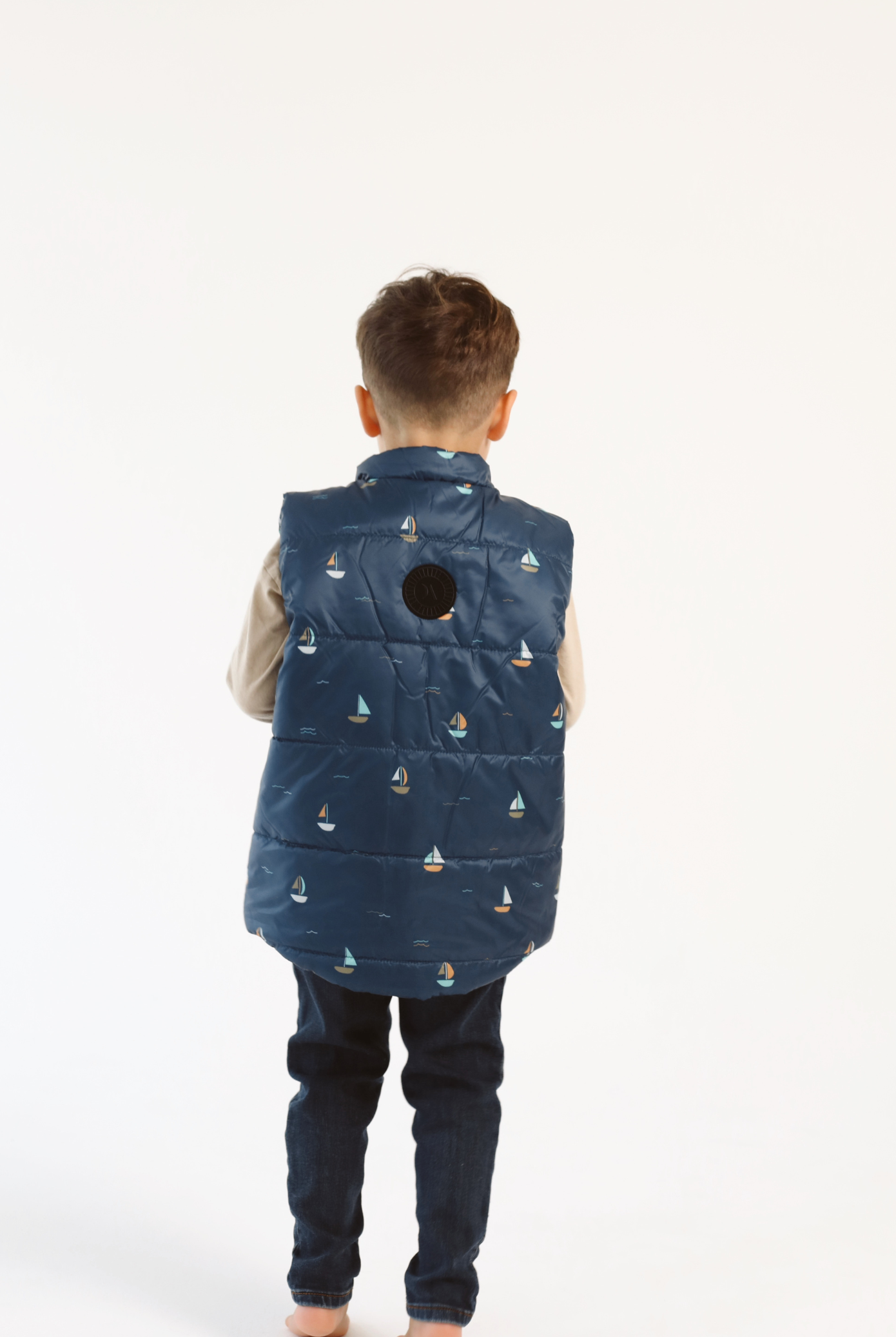 Kids Boats x Navy Gilet™ — sleeveless navy puffer vest with playful boat print, a versatile layer for kids in South Africa