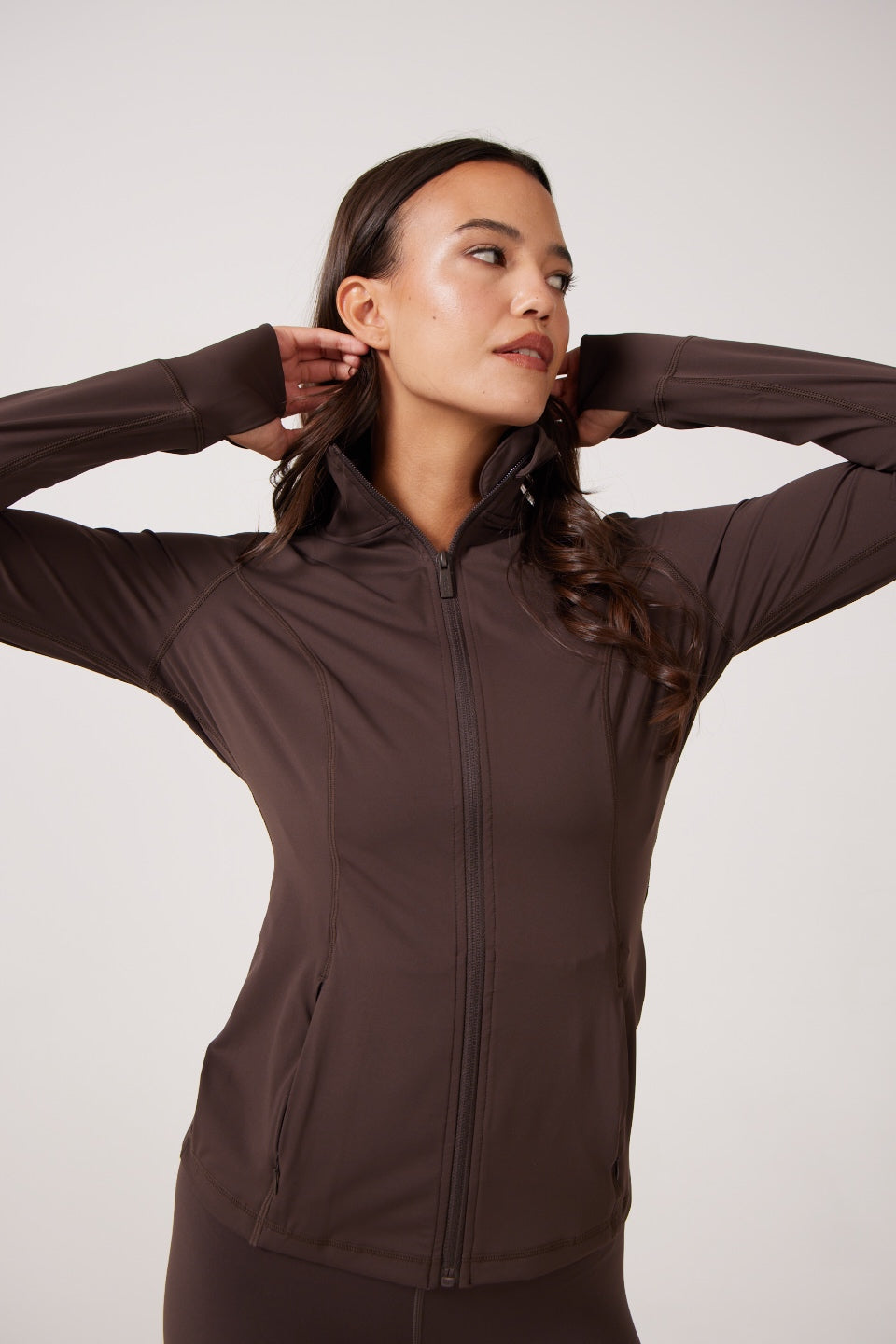 Brown Lightweight performance jacket with a smooth, sculpting fit, full zip front, high collar, and stretch fabric designed for everyday movement and layering.