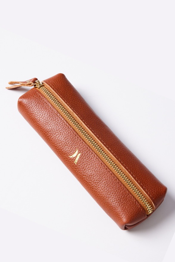 Leather Vanity Bags — assorted colors including orange, pink, red, tan, and black, each with gold zipper detail