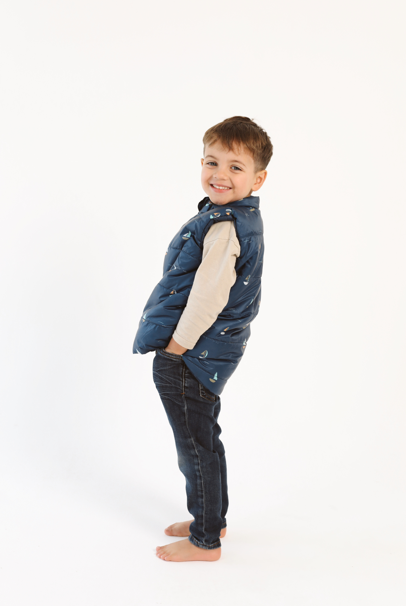 Kids Boats x Navy Gilet™ — sleeveless navy puffer vest with playful boat print, a versatile layer for kids in South Africa