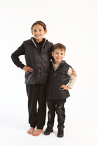 Kids Houndstooth x Black Gilet™ — sleeveless black puffer vest with bold houndstooth print, a versatile winter layer for kids in South Africa