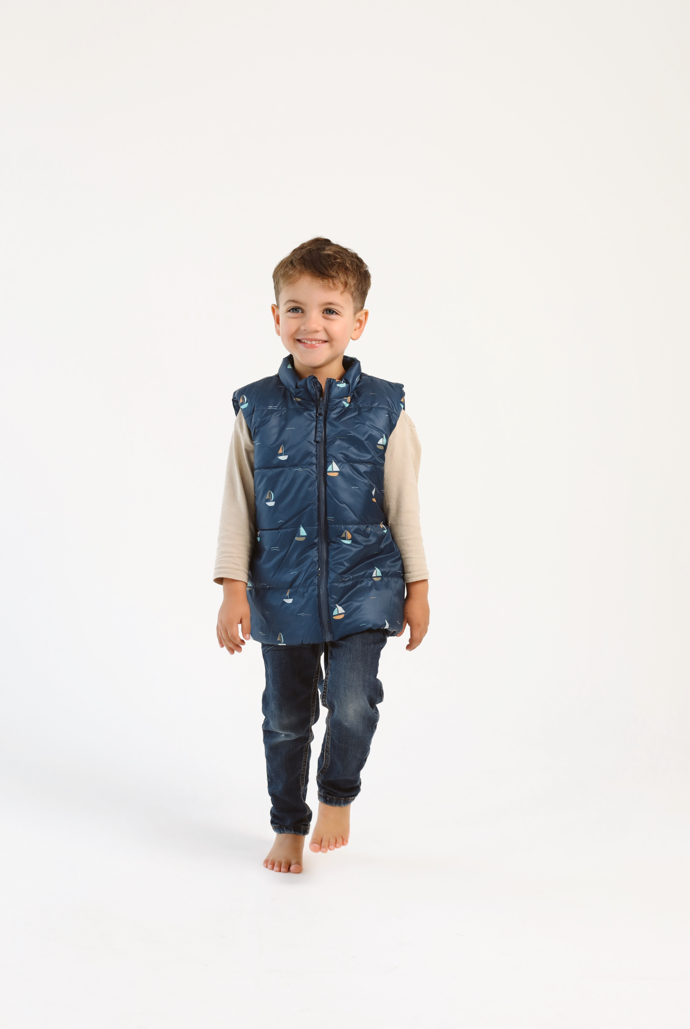 Kids Boats x Navy Gilet™ — sleeveless navy puffer vest with playful boat print, a versatile layer for kids in South Africa