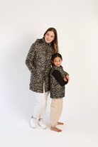 Kids Leopard x Black Gilet™ — sleeveless kids’ puffer vest in bold leopard print with black accents, a fun winter essential in South Africa