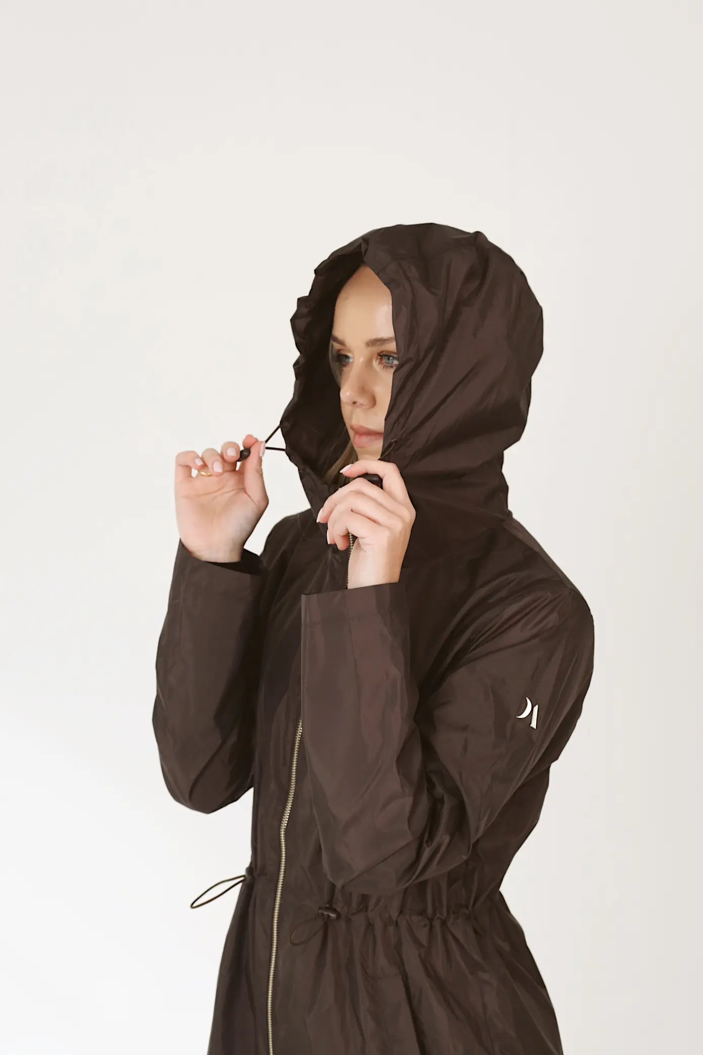 Truffle Haze raincoat in dark brown, lightweight hooded waterproof raincoat ideal for South Africa’s rainy season and wet climate