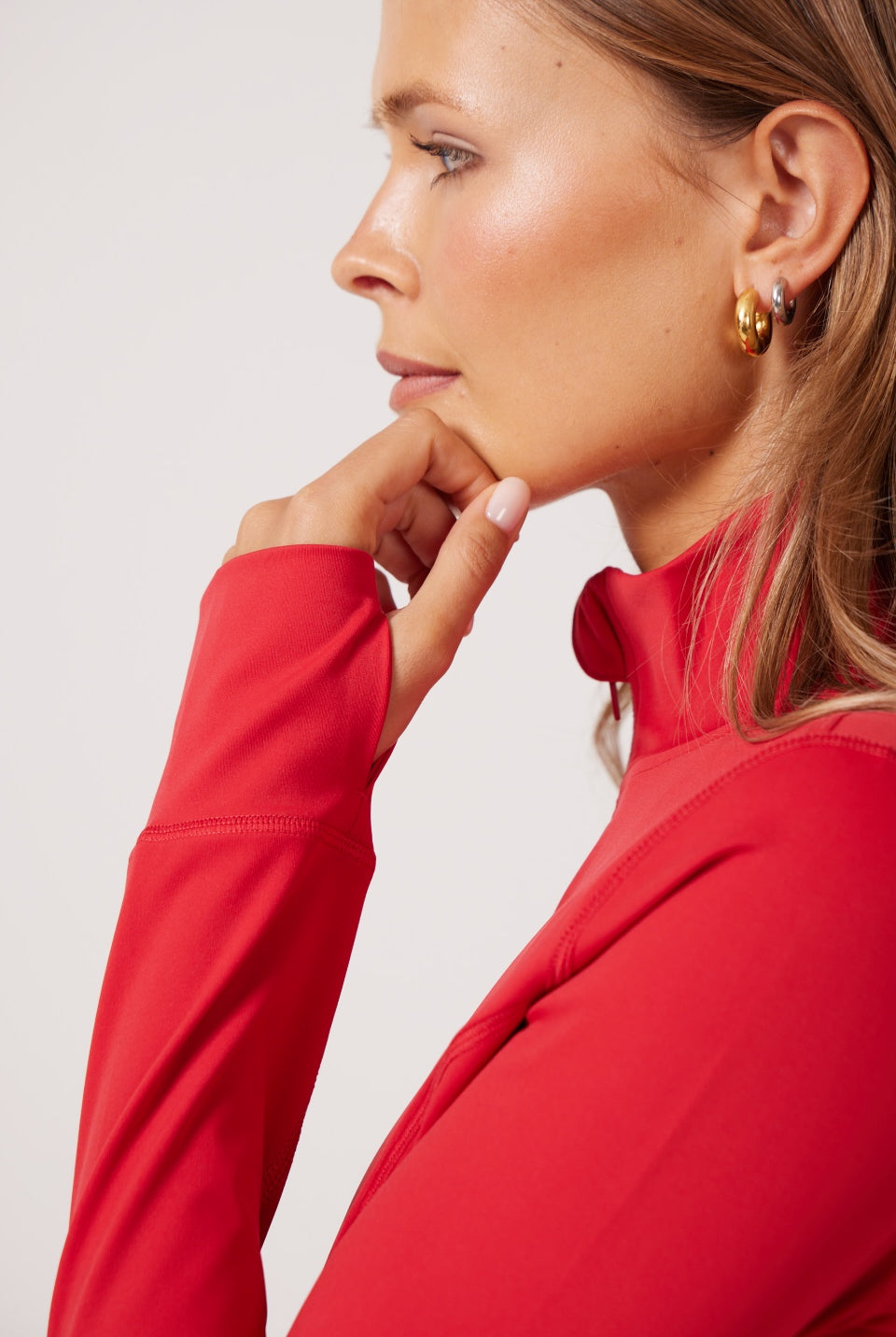 Red Lightweight performance jacket with a smooth, sculpting fit, full zip front, high collar, and stretch fabric designed for everyday movement and layering.