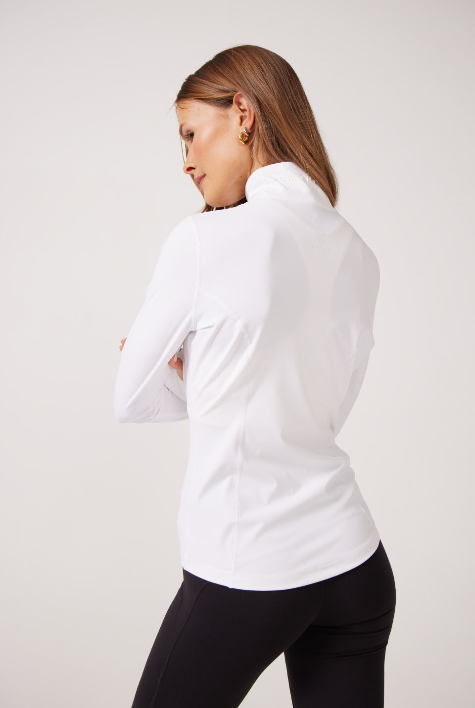 White Lightweight performance jacket with a smooth, sculpting fit, full zip front, high collar, and stretch fabric designed for everyday movement and layering.