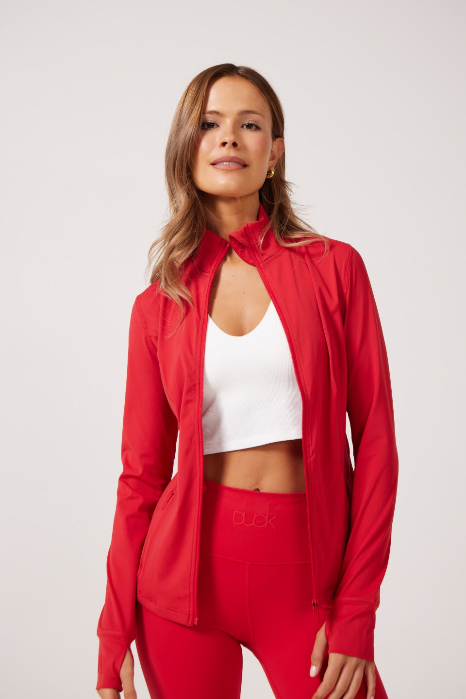 Red Lightweight performance jacket with a smooth, sculpting fit, full zip front, high collar, and stretch fabric designed for everyday movement and layering.