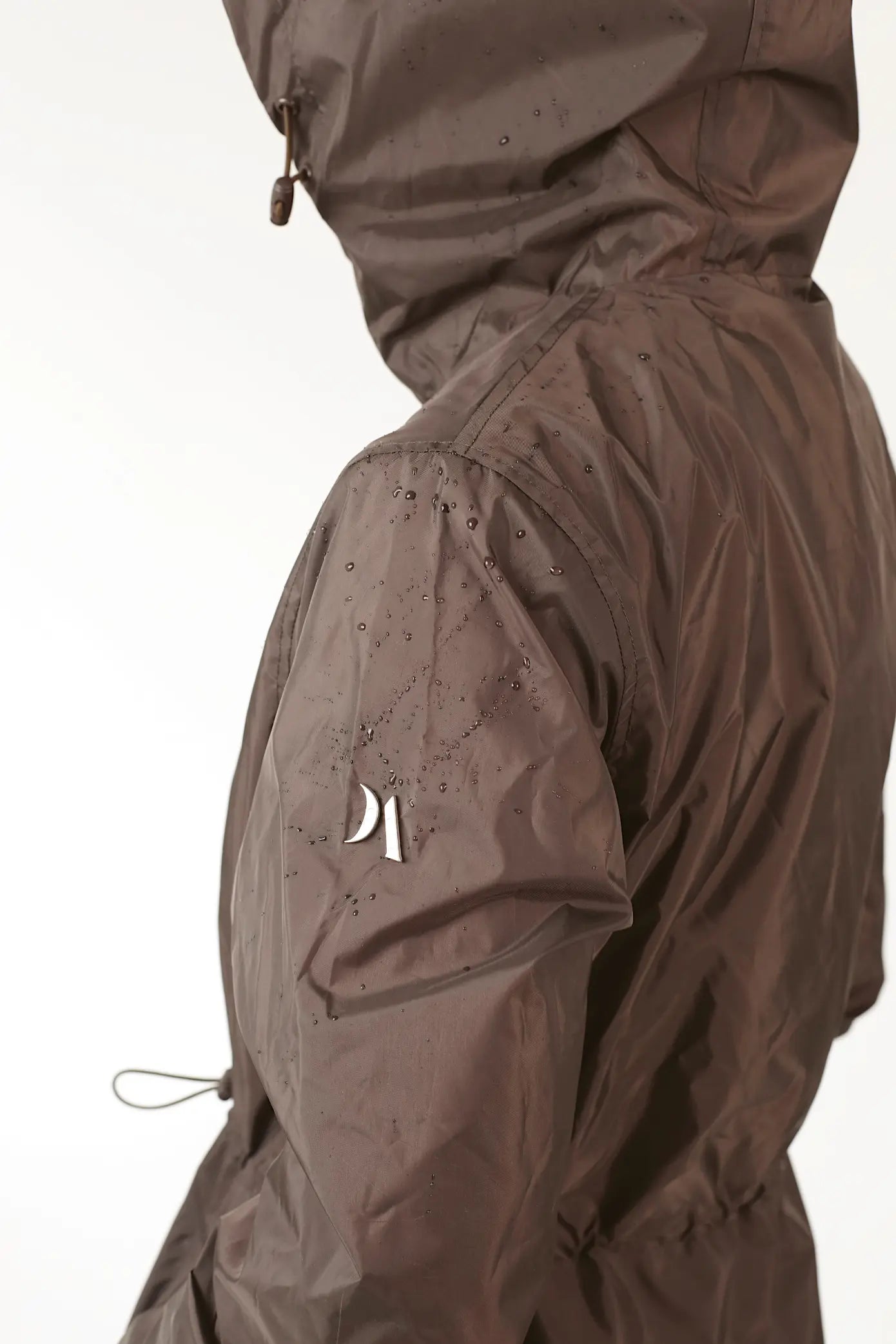 Truffle Haze raincoat in dark brown, lightweight hooded waterproof raincoat ideal for South Africa’s rainy season and wet climate