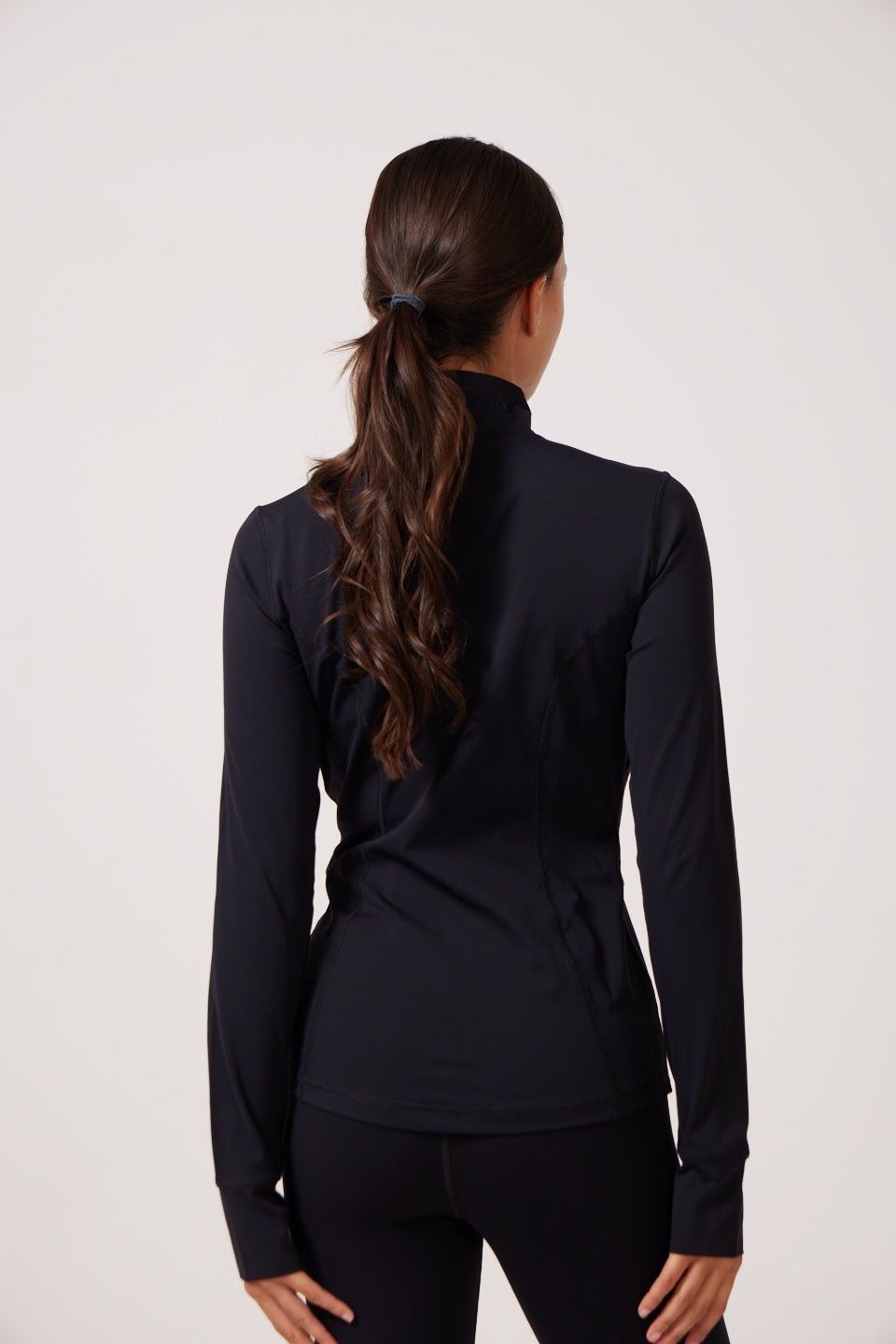 Black Lightweight performance jacket with a smooth, sculpting fit, full zip front, high collar, and stretch fabric designed for everyday movement and layering.