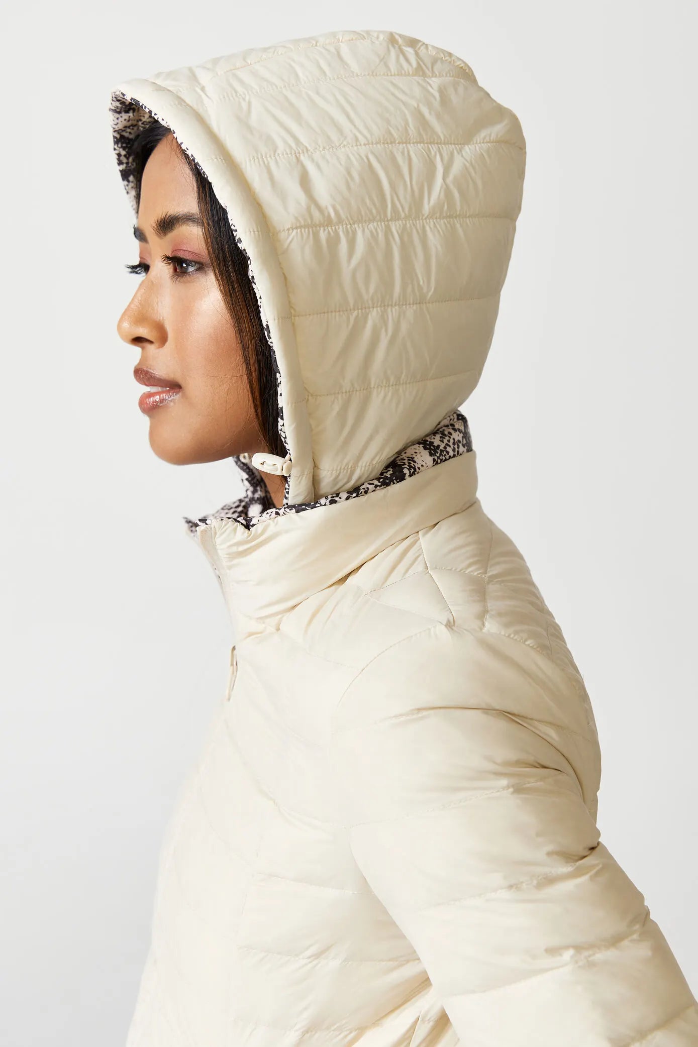 Women’s reversible cream puffer jacket with python-print inner lining and hood, lightweight insulated outerwear from Duck Apparel South Africa
