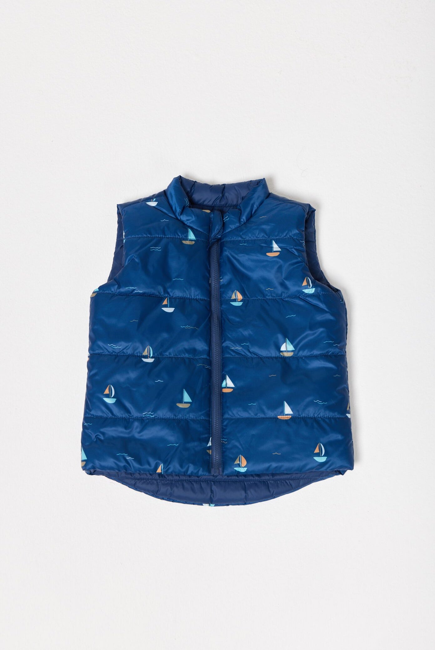 Kids Boats x Navy Gilet™ — sleeveless navy puffer vest with playful boat print, a versatile layer for kids in South Africa