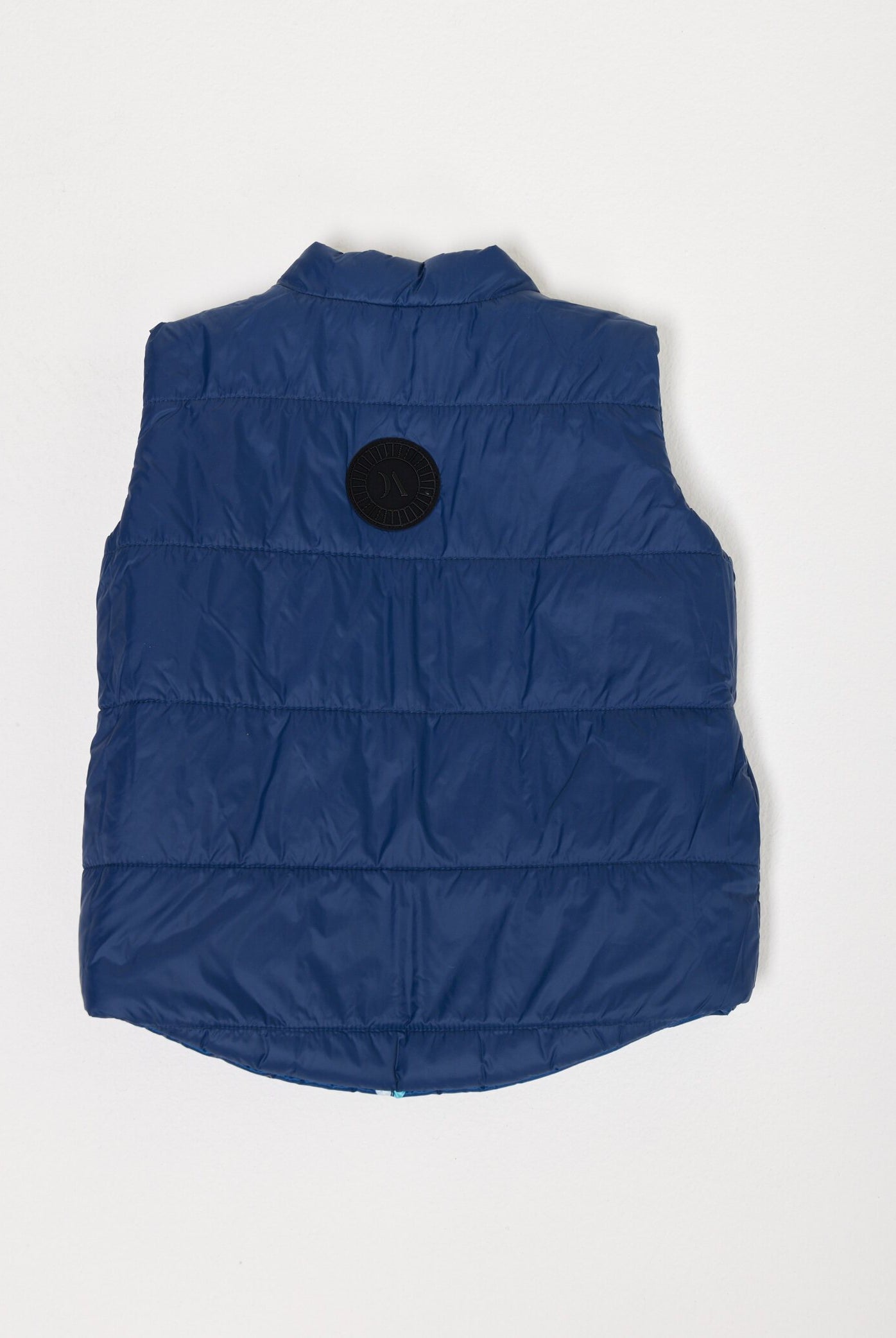 Kids Boats x Navy Gilet™ — sleeveless navy puffer vest with playful boat print, a versatile layer for kids in South Africa