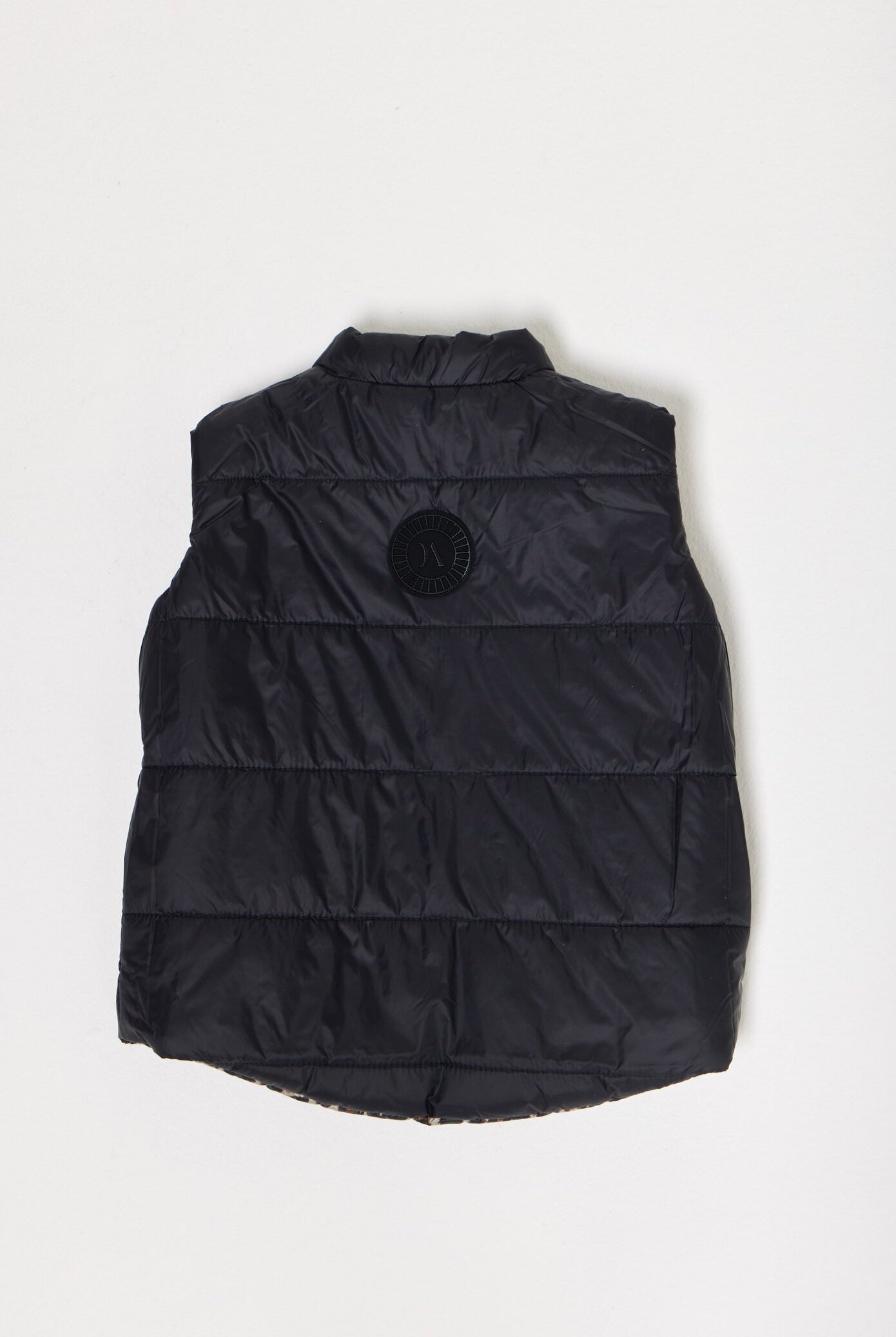 Kids Leopard x Black Gilet™ — sleeveless kids’ puffer vest in bold leopard print with black accents, a fun winter essential in South Africa