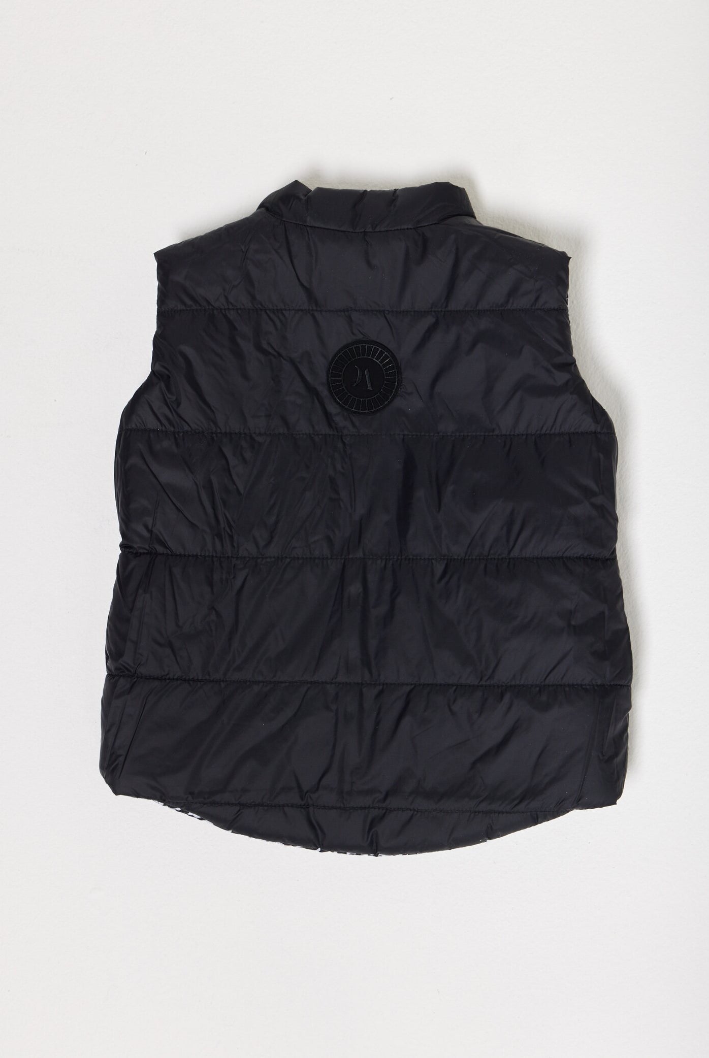 Kids Houndstooth x Black Gilet™ — sleeveless black puffer vest with bold houndstooth print, a versatile winter layer for kids in South Africa