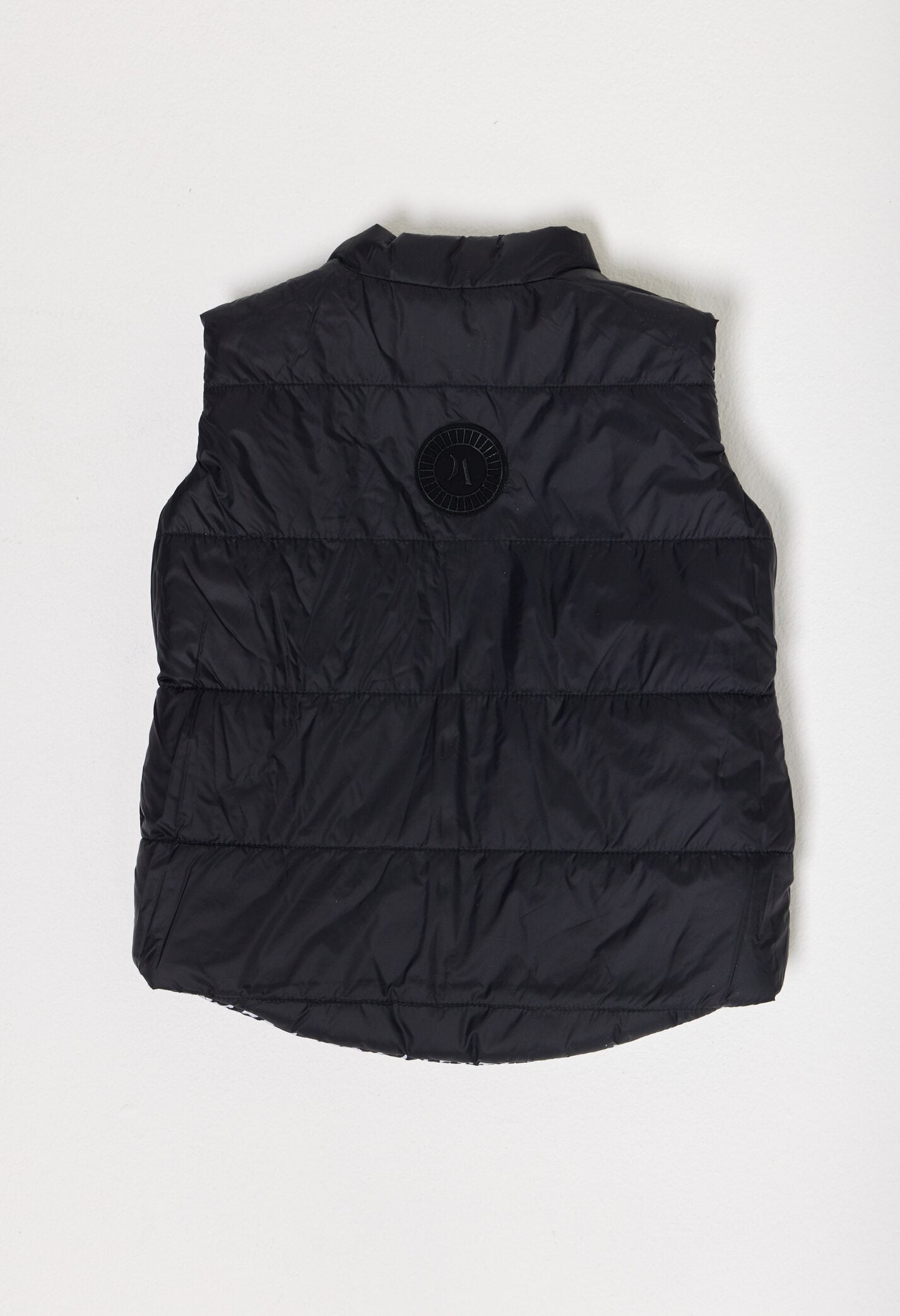 Kids Houndstooth x Black Gilet™ — sleeveless black puffer vest with bold houndstooth print, a versatile winter layer for kids in South Africa