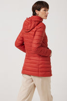 Women’s insulated hooded parka in rust red, designed for warmth and comfort in South Africa’s winter season — Rust Classic Parka™