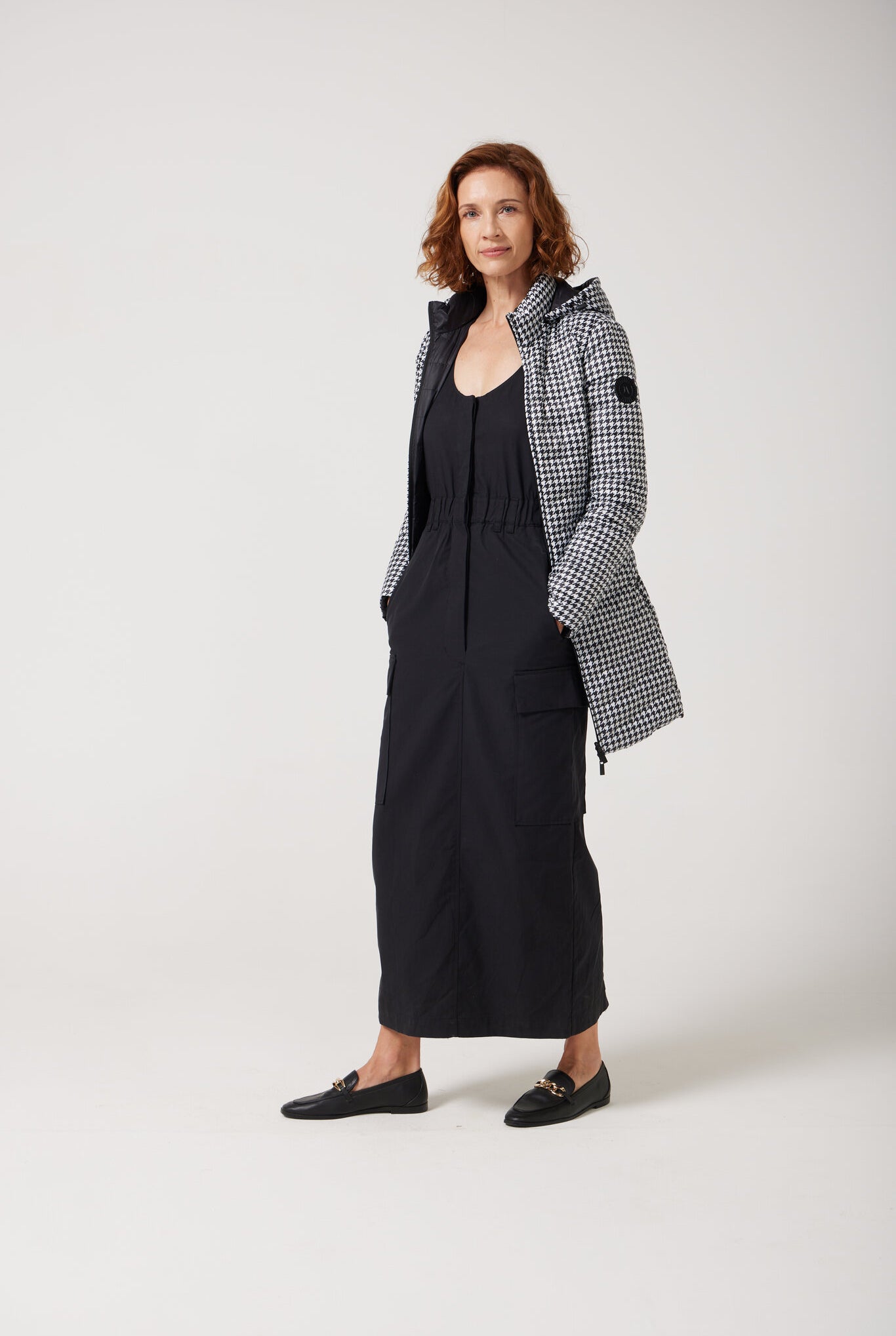 Women’s insulated reversible hooded parka in houndstooth print and midnight black, designed for warmth and comfort in South Africa’s winter season — Midnight x Houndstooth Classic Parka™