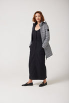 Women’s insulated reversible hooded parka in houndstooth print and midnight black, designed for warmth and comfort in South Africa’s winter season — Midnight x Houndstooth Classic Parka™