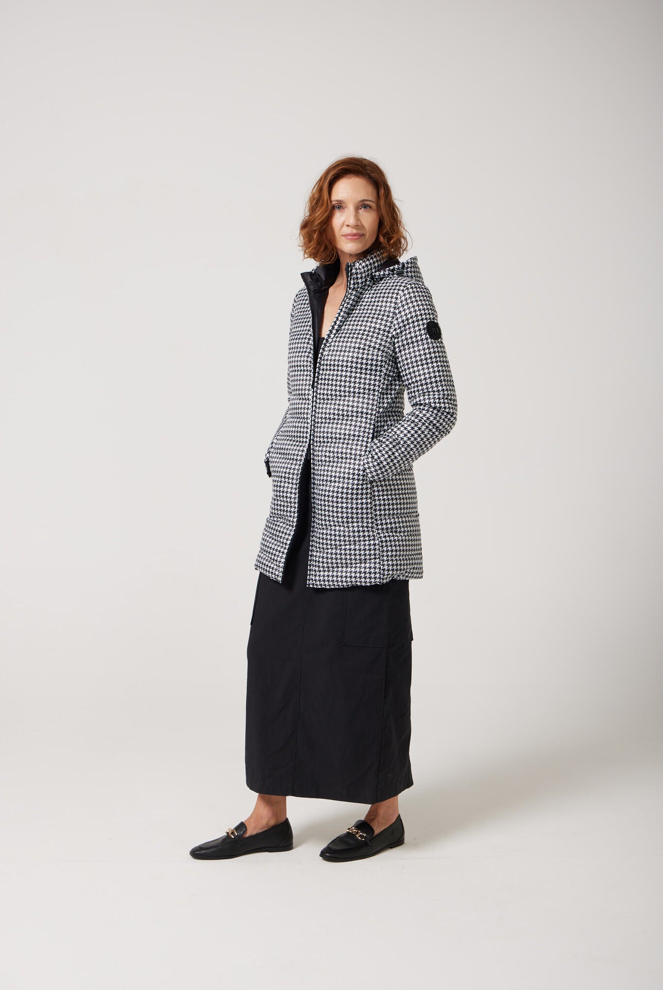 Women’s insulated reversible hooded parka in houndstooth print and midnight black, designed for warmth and comfort in South Africa’s winter season — Midnight x Houndstooth Classic Parka™