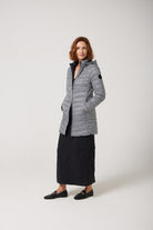 Women’s insulated reversible hooded parka in houndstooth print and midnight black, designed for warmth and comfort in South Africa’s winter season — Midnight x Houndstooth Classic Parka™