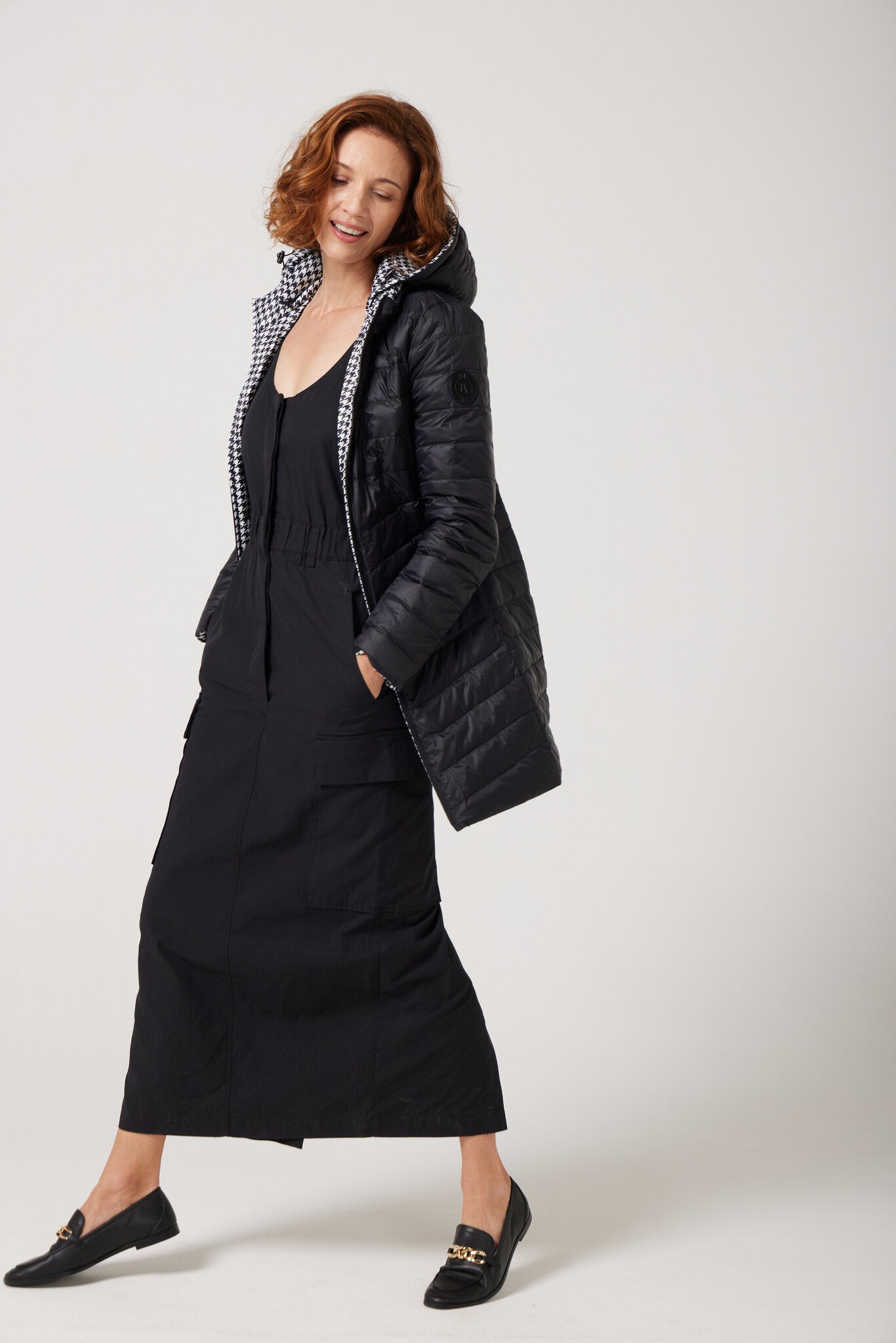 Women’s insulated reversible hooded parka in houndstooth print and midnight black, designed for warmth and comfort in South Africa’s winter season — Midnight x Houndstooth Classic Parka™