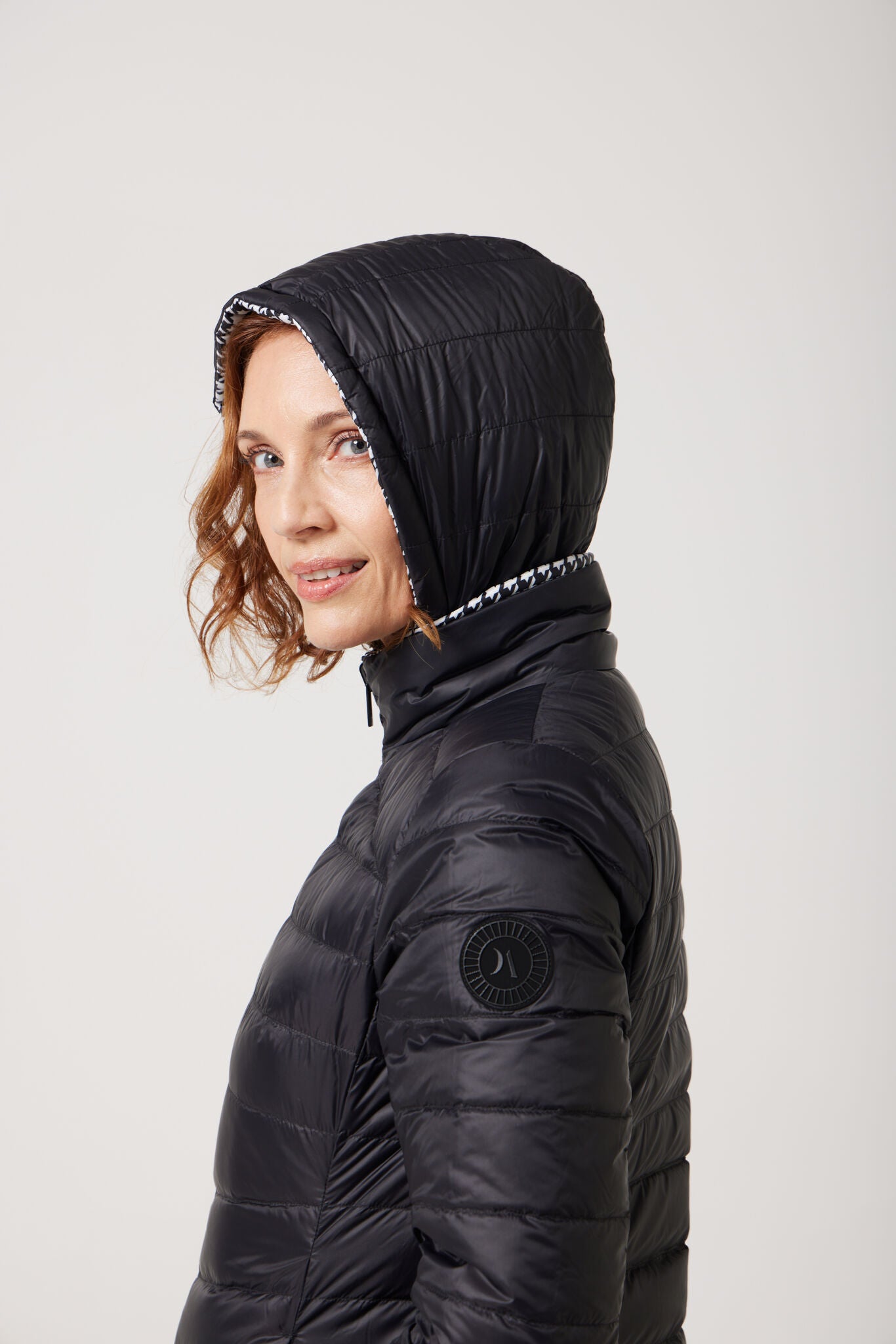Women’s insulated reversible hooded parka in houndstooth print and midnight black, designed for warmth and comfort in South Africa’s winter season — Midnight x Houndstooth Classic Parka™