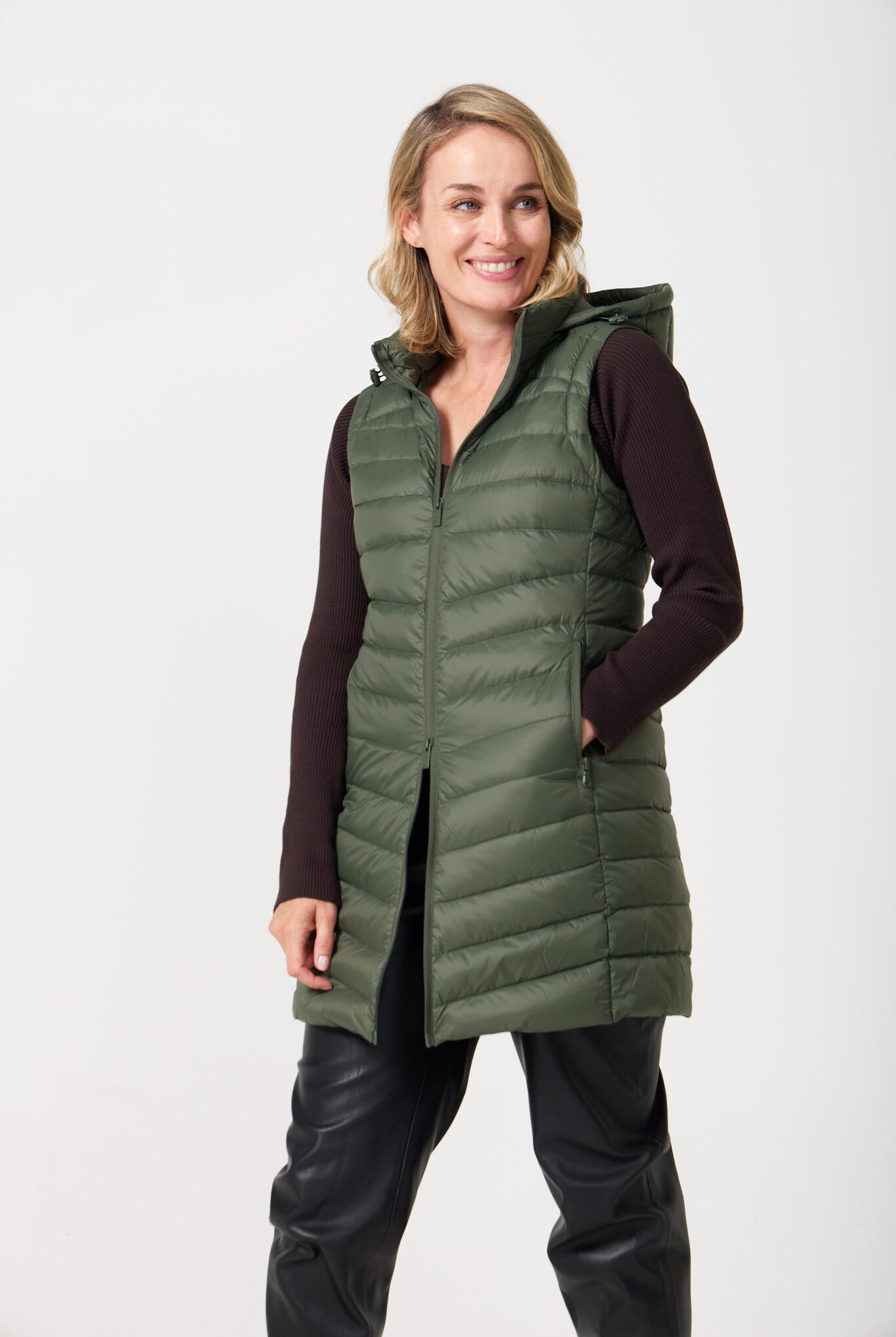 Sage Longline Gilet™ — women’s sleeveless gilet in sage green, extra length with hood, versatile for layering in winter an essential in South Africa