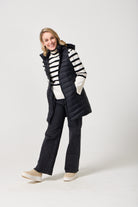 Midnight Longline Gilet™ — women’s sleeveless gilet in black, longline cut with hood, versatile layering piece for winter in South Africa.