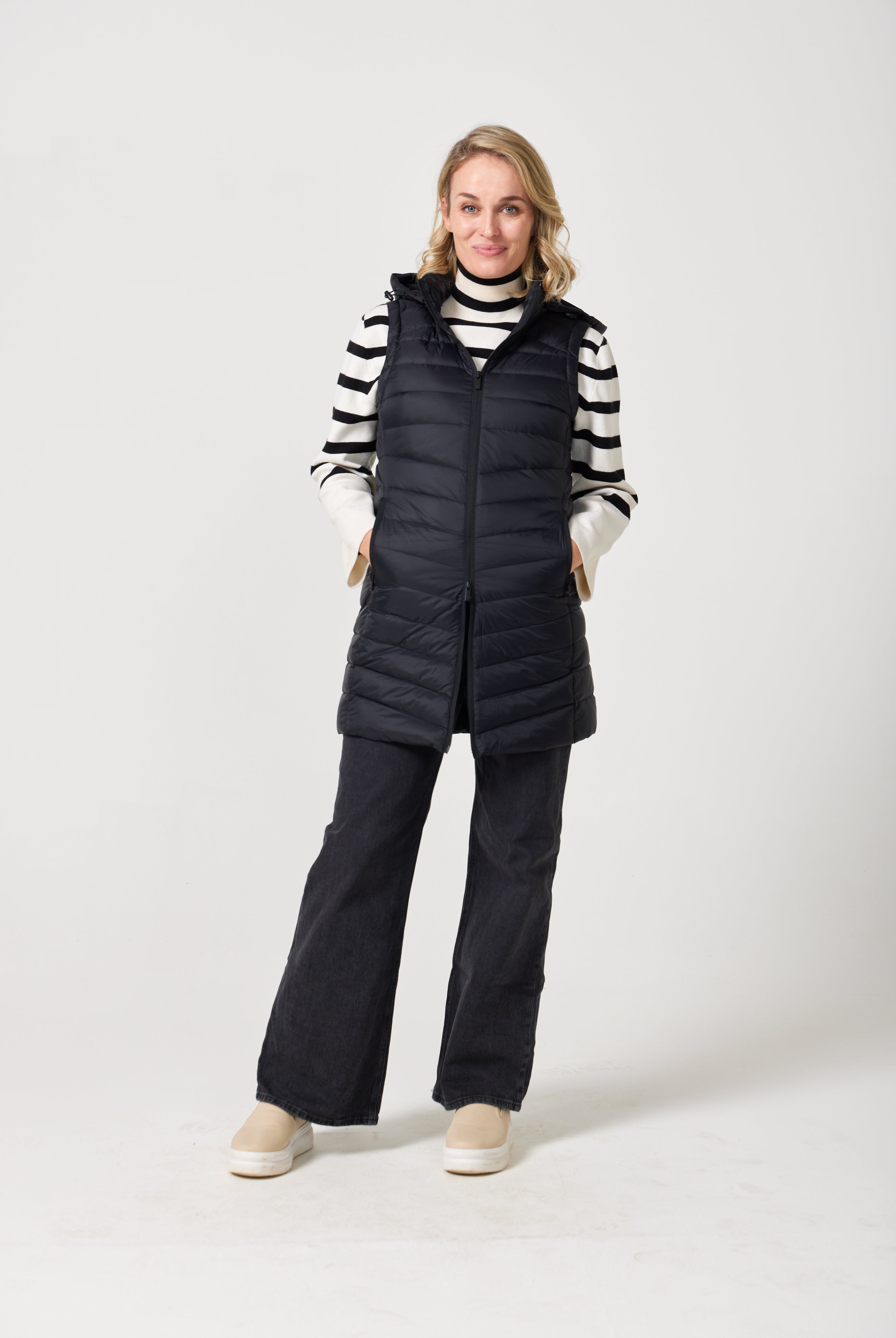 Midnight Longline Gilet™ — women’s sleeveless gilet in black, longline cut with hood, versatile layering piece for winter in South Africa.