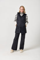 Midnight Longline Gilet™ — women’s sleeveless gilet in black, longline cut with hood, versatile layering piece for winter in South Africa.