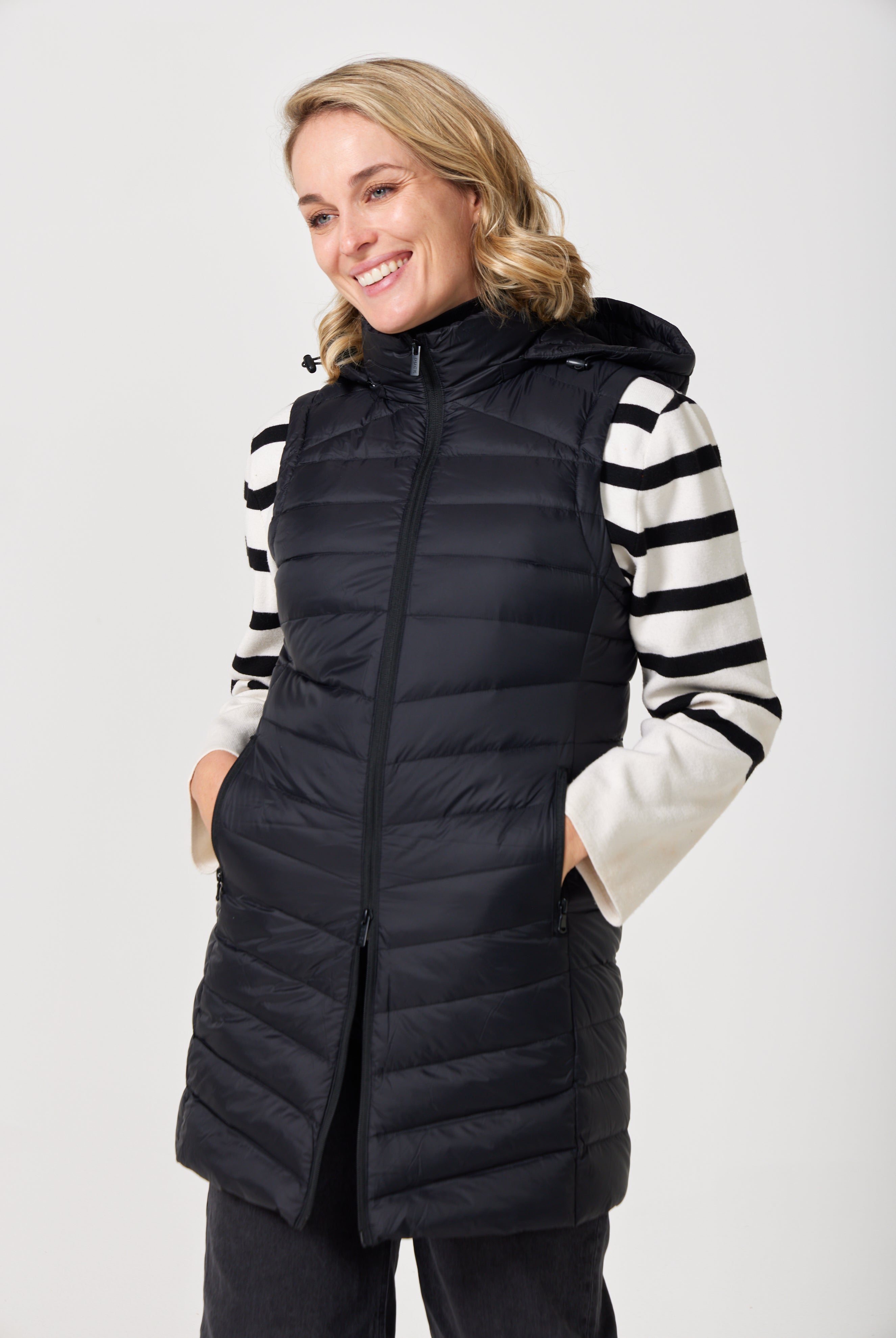 Midnight Longline Gilet™ — women’s sleeveless gilet in black, longline cut with hood, versatile layering piece for winter in South Africa.