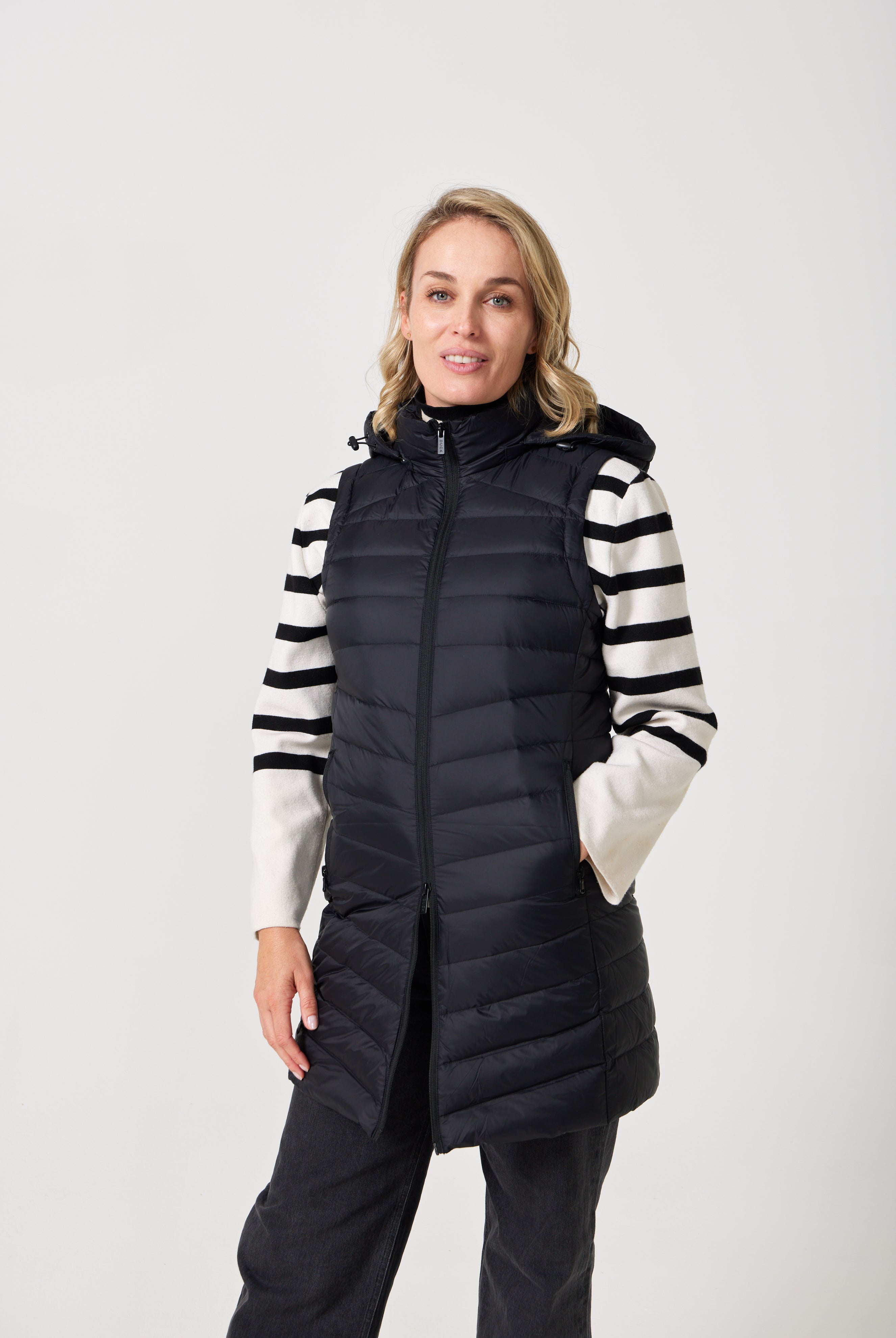 Midnight Longline Gilet™ — women’s sleeveless gilet in black, longline cut with hood, versatile layering piece for winter in South Africa.