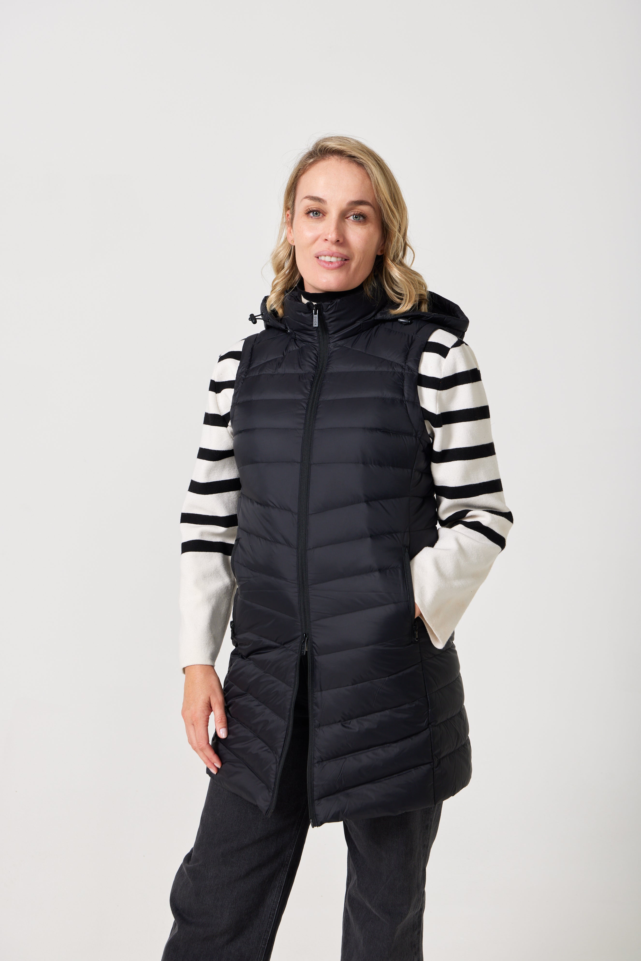 Midnight Longline Gilet™ — women’s sleeveless gilet in black, longline cut with hood, versatile layering piece for winter in South Africa.