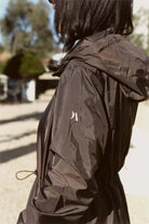 Truffle Haze raincoat in dark brown, lightweight hooded waterproof raincoat ideal for South Africa’s rainy season and wet climate