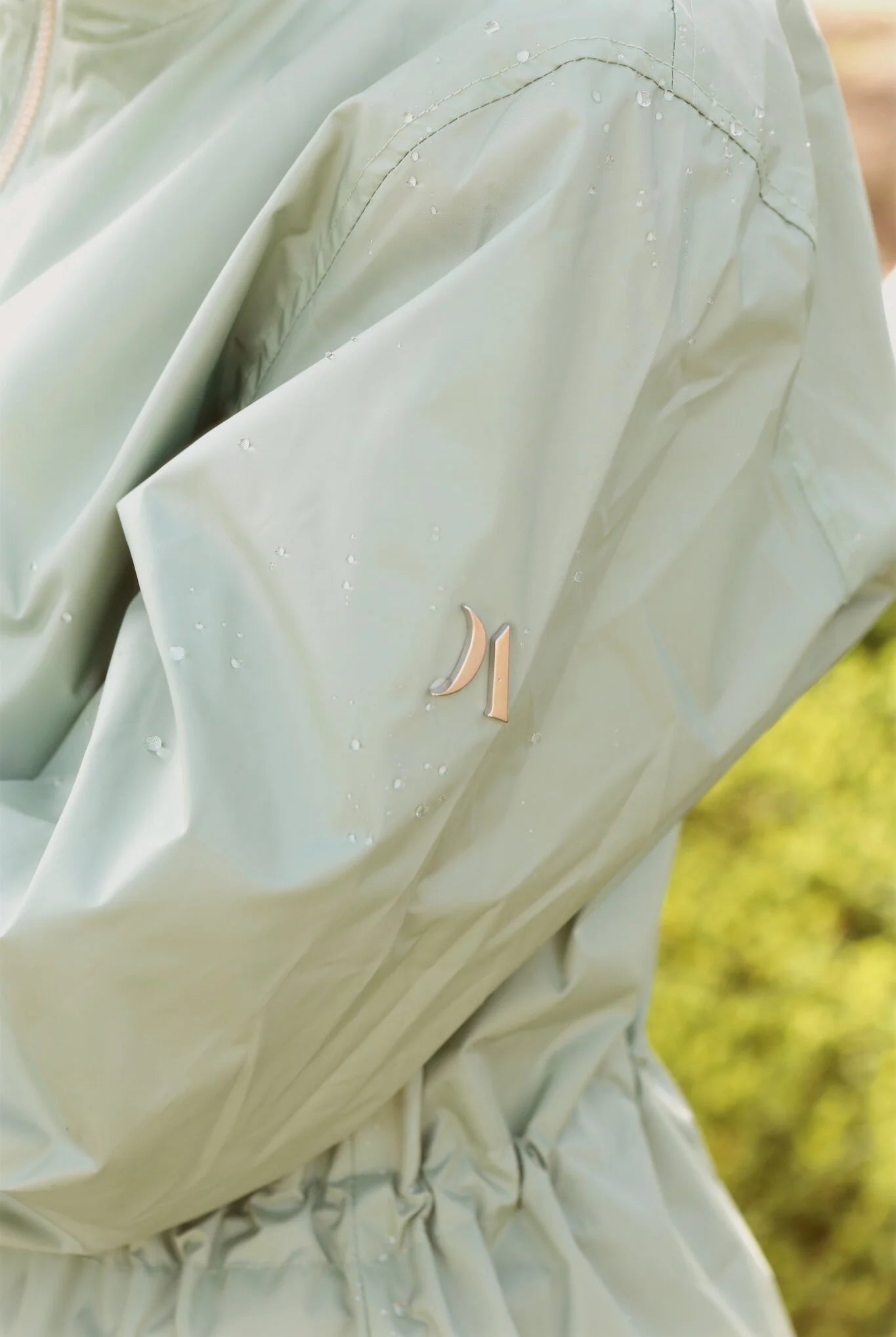 Madame Verde Vol 1 raincoat in light green with hood, stylish waterproof jacket for rainy days in South Africa