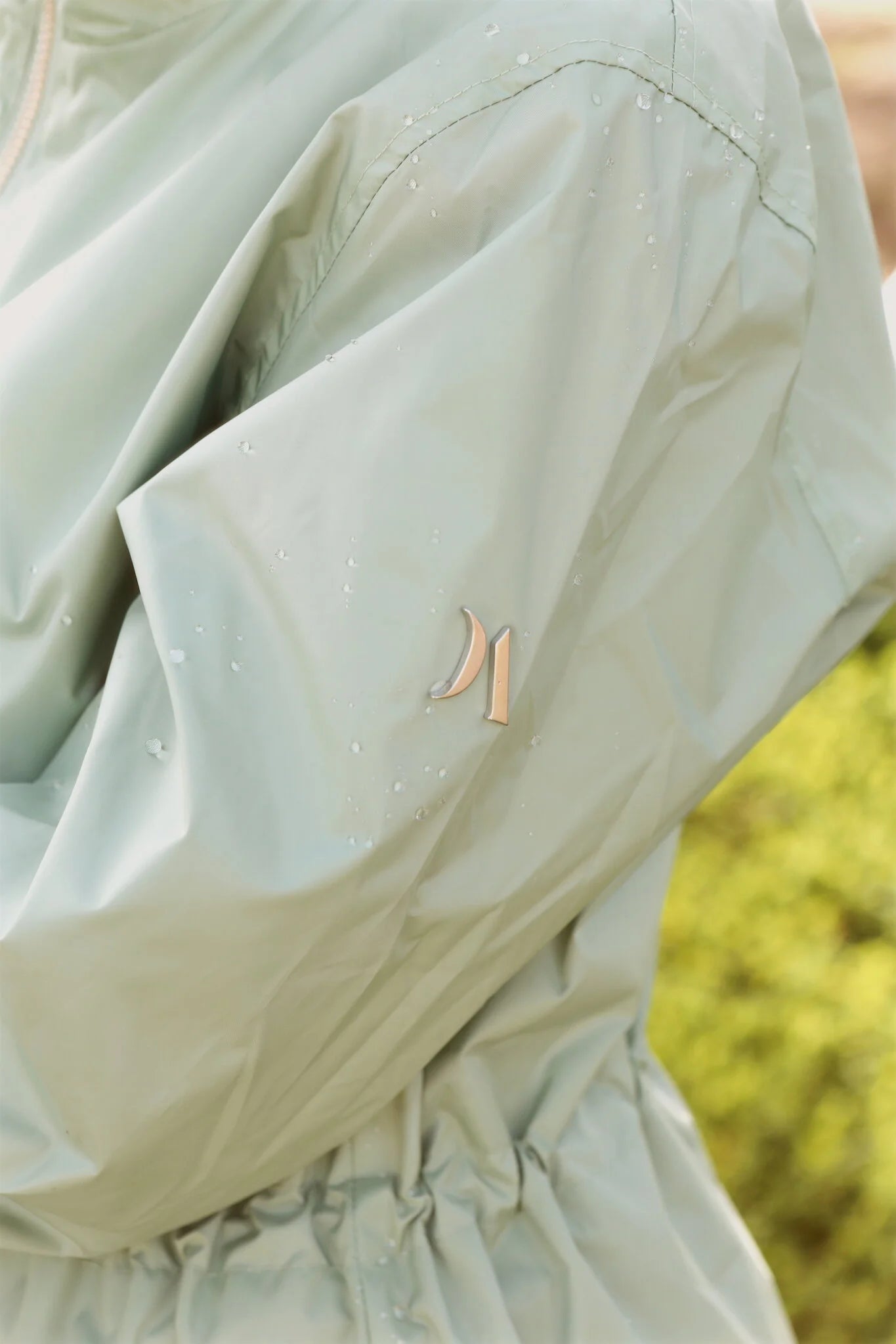 Madame Verde Vol 1 raincoat in light green with hood, stylish waterproof jacket for rainy days in South Africa