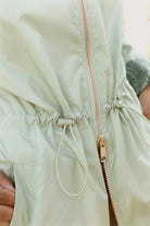 Madame Verde Vol 1 raincoat in light green with hood, stylish waterproof jacket for rainy days in South Africa