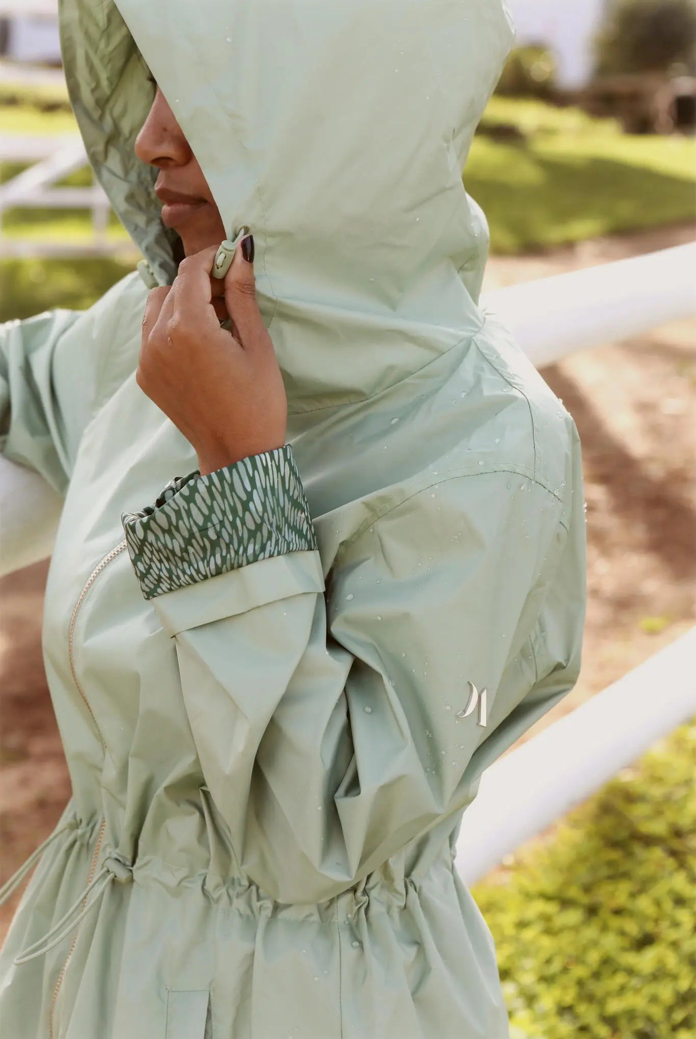 Madame Verde Vol 1 raincoat in light green with hood, stylish waterproof jacket for rainy days in South Africa